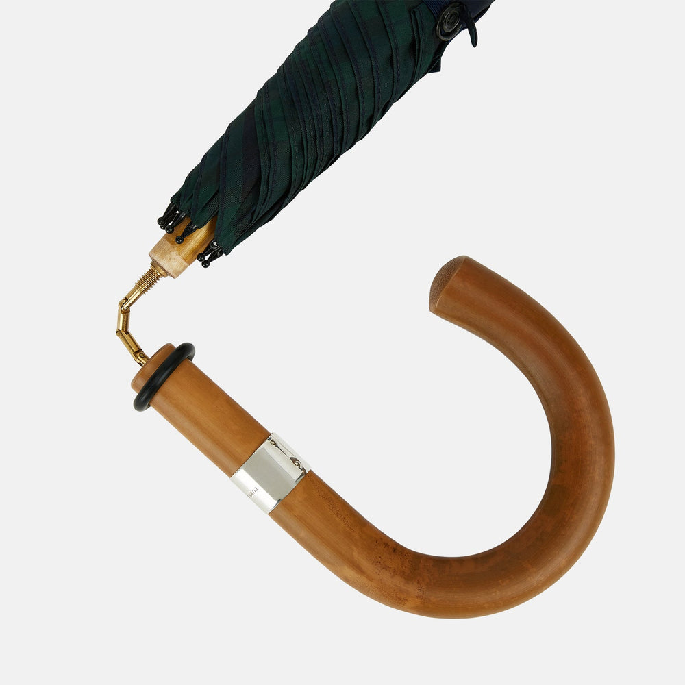 The Turnbull & Asser Black Watch Tartan Traveller Umbrella features a Malacca crook handle and a dark green and navy blue plaid canopy, shown against a plain white background.
