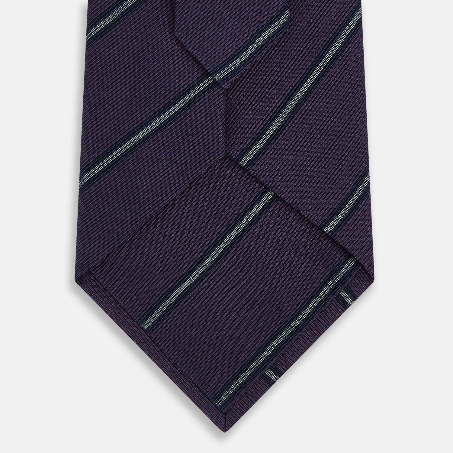 View 3 of product The Turnbull & Asser Purple Multi Stripe Silk Blend Tie, featuring thin light blue diagonal stripes, is neatly rolled on a white background.