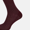 View 3 of product The Turnbull & Asser Burgundy Motif Long Sock, made from mercerised Egyptian cotton with a subtle diamond motif, is shown knee-high on a plain white background.
