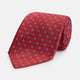 The Turnbull & Asser MINI SQUARE SPOT TULIP RED BLUE TIE features a vivid red base with blue and white geometric spots, making it a stylish addition to any refined ensemble.