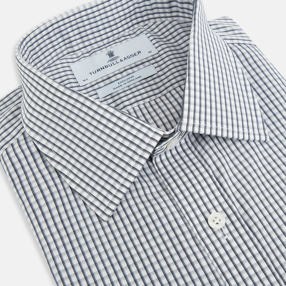 The Grey Double Graph Mayfair Shirt by Turnbull & Asser is a long-sleeve, button-down cotton shirt with a black and white double graph check, chest pocket, and classic collar.