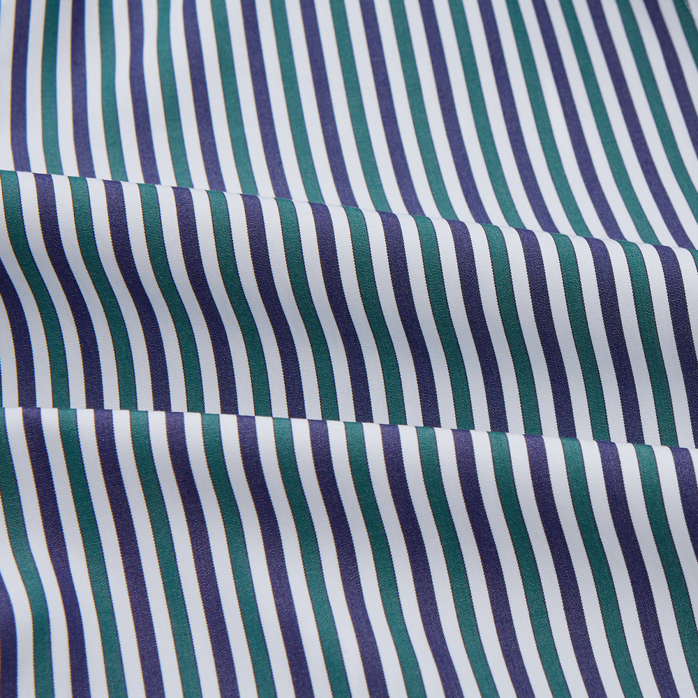 The Turnbull & Asser Green and Blue Stripe Cotton Arnold Gown features long sleeves, a knee-length cut, a shawl collar, front pockets, and an elegant wrap belt at the waist.