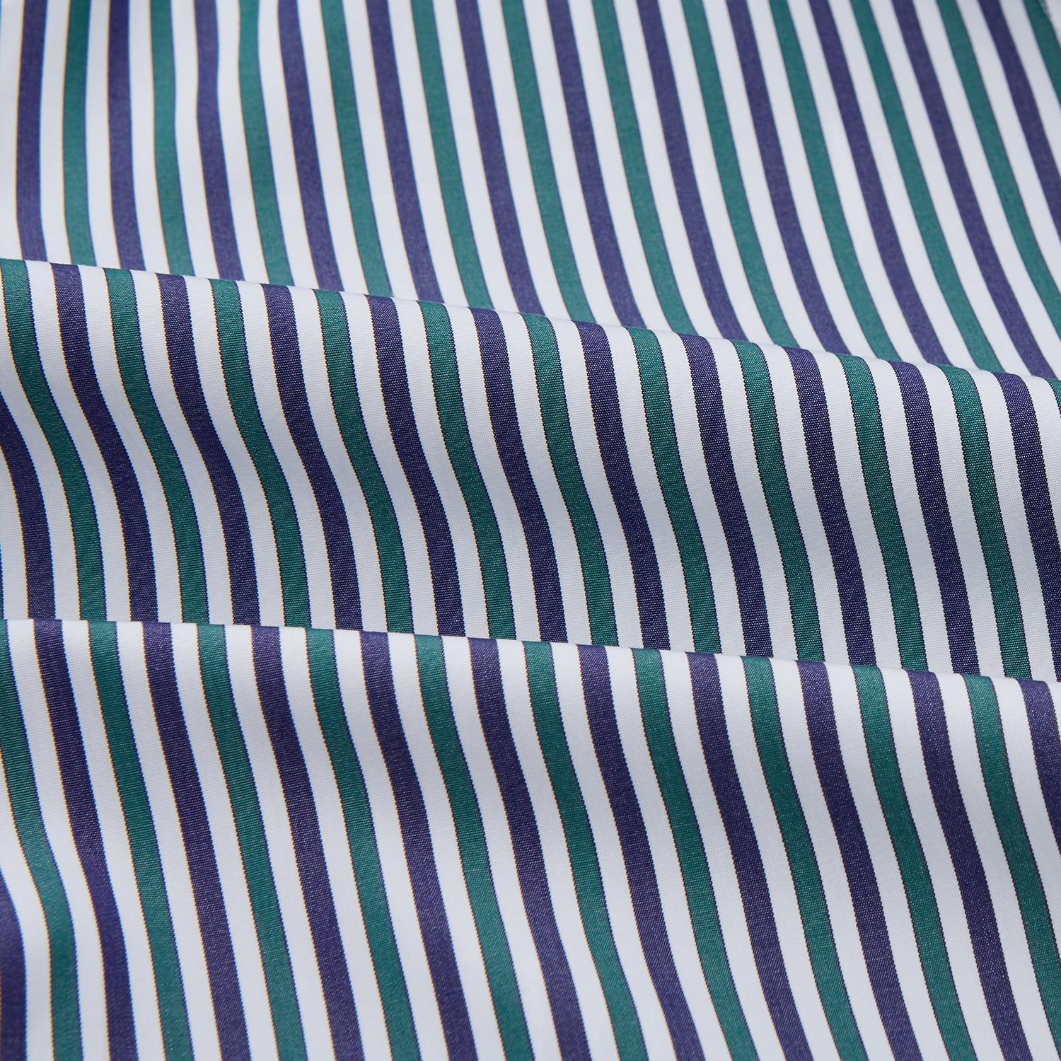 View 4 of product The Turnbull & Asser Green and Blue Stripe Cotton Arnold Gown features long sleeves, a knee-length cut, a shawl collar, front pockets, and an elegant wrap belt at the waist.