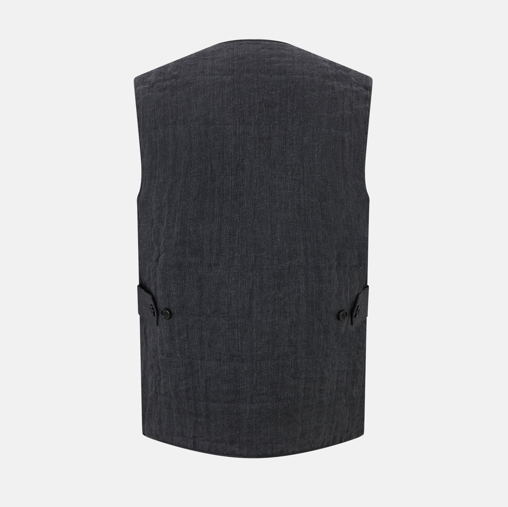 The Turnbull & Asser Ash Quilted Linen Herringbone Waistcoat is sleeveless and dark gray with a V-neck, two zippered side pockets, and a small chest pocket, shown on a plain white background.