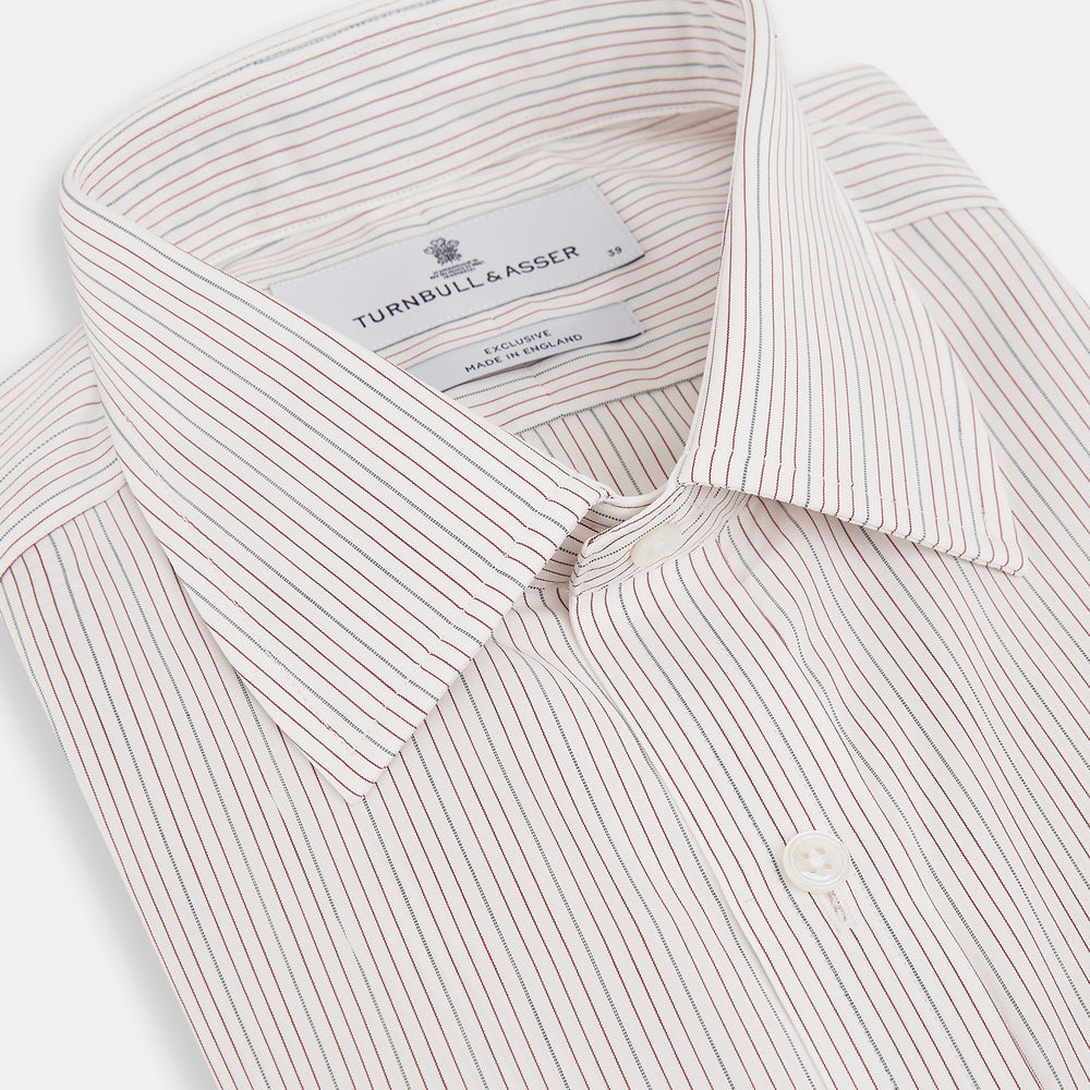 The Turnbull & Asser Burgundy Multi Hairline Stripe Mayfair Shirt features long sleeves, a classic collar, buttoned cuffs, and slim vertical stripes—ideal for formal wear and shown against a plain white background.