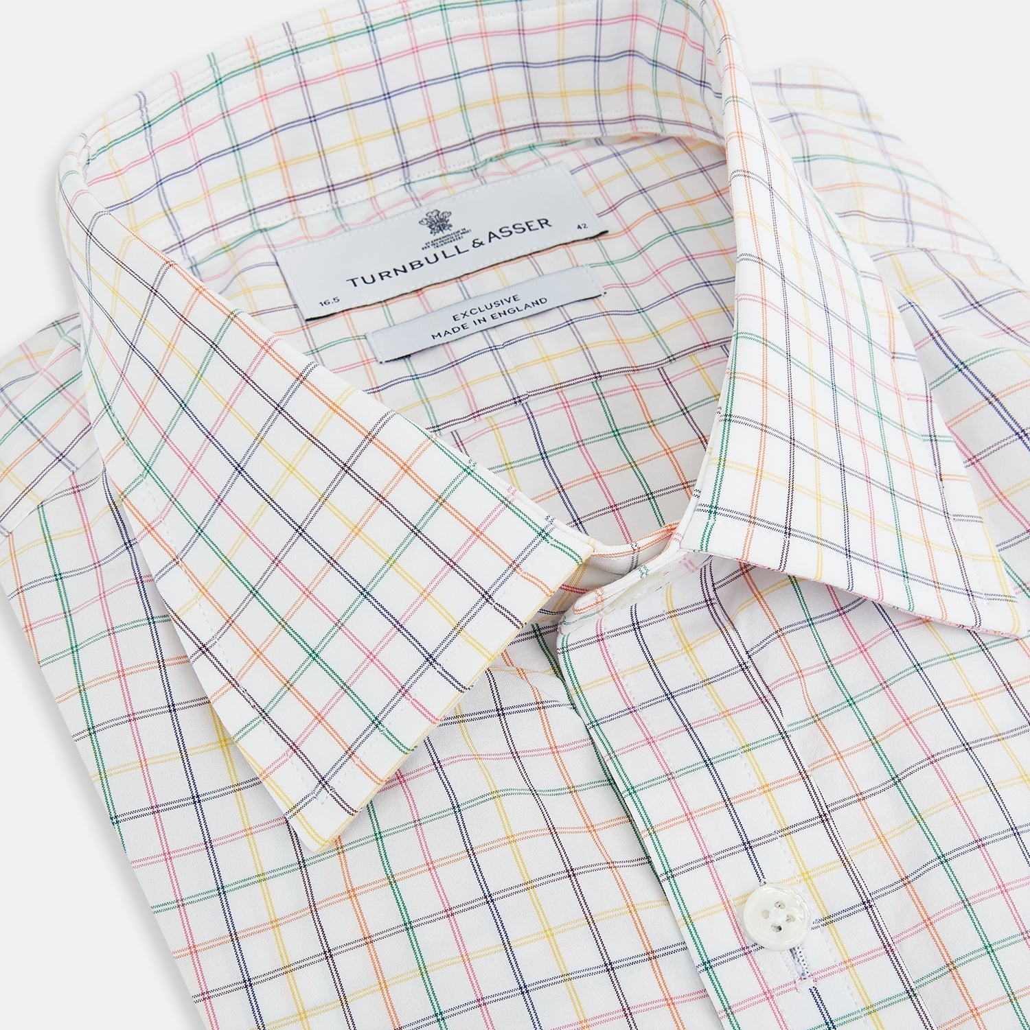 View 2 of product The Rainbow Double Grid Check Mayfair Shirt by Turnbull & Asser features a white base with thin blue, red, and green checks and a T&A collar. It’s displayed neatly laid flat on a white background.