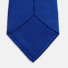 View 4 of product The Turnbull & Asser Plain Herringbone Cruise Tie in bright blue, shown rolled up on a white background, features a subtle chevron pattern—an essential finishing touch for your smart look.