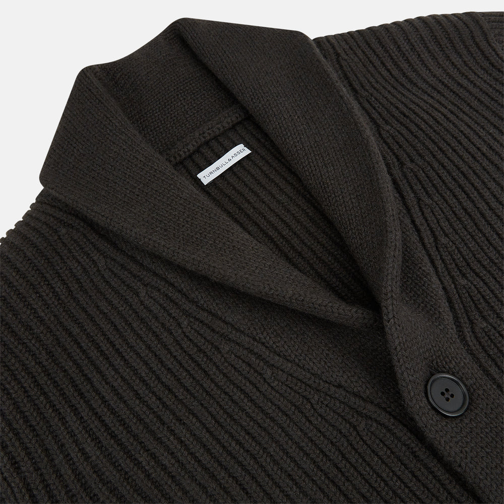 The Turnbull & Asser Dark Brown Cashmere Shawl Collar Cardigan features a ribbed knit, five black front buttons, and two front pockets, highlighting handcrafted quality against a white background.