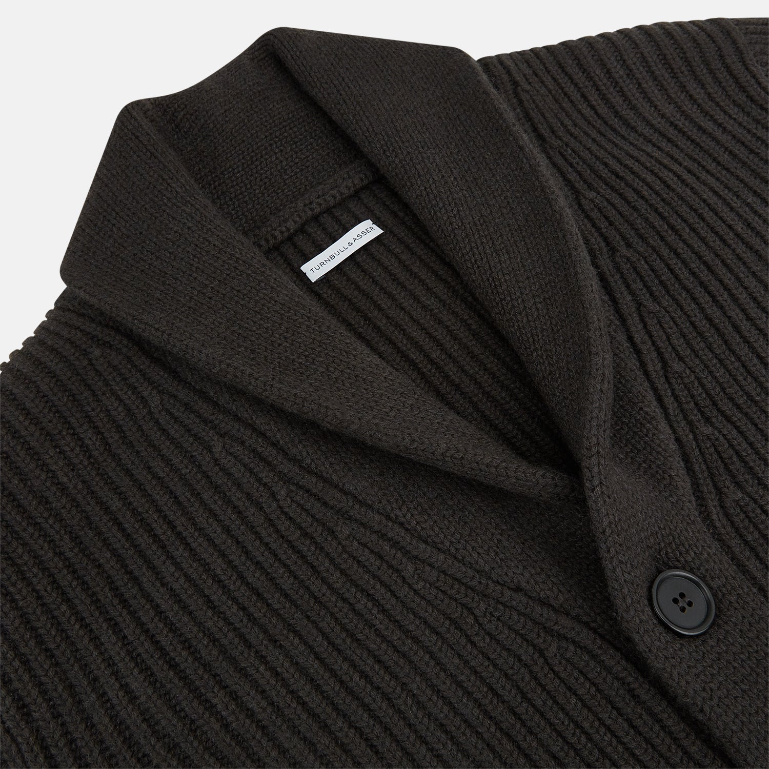 View 2 of product The Turnbull & Asser Dark Brown Cashmere Shawl Collar Cardigan features a ribbed knit, five black front buttons, and two front pockets, highlighting handcrafted quality against a white background.