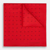 View 1 of product The Turnbull & Asser Red and Burgundy Spot Silk Pocket Square features evenly spaced small spots and the brand logo in the bottom right corner—perfect for formal wear. One corner is folded to show the reverse side.