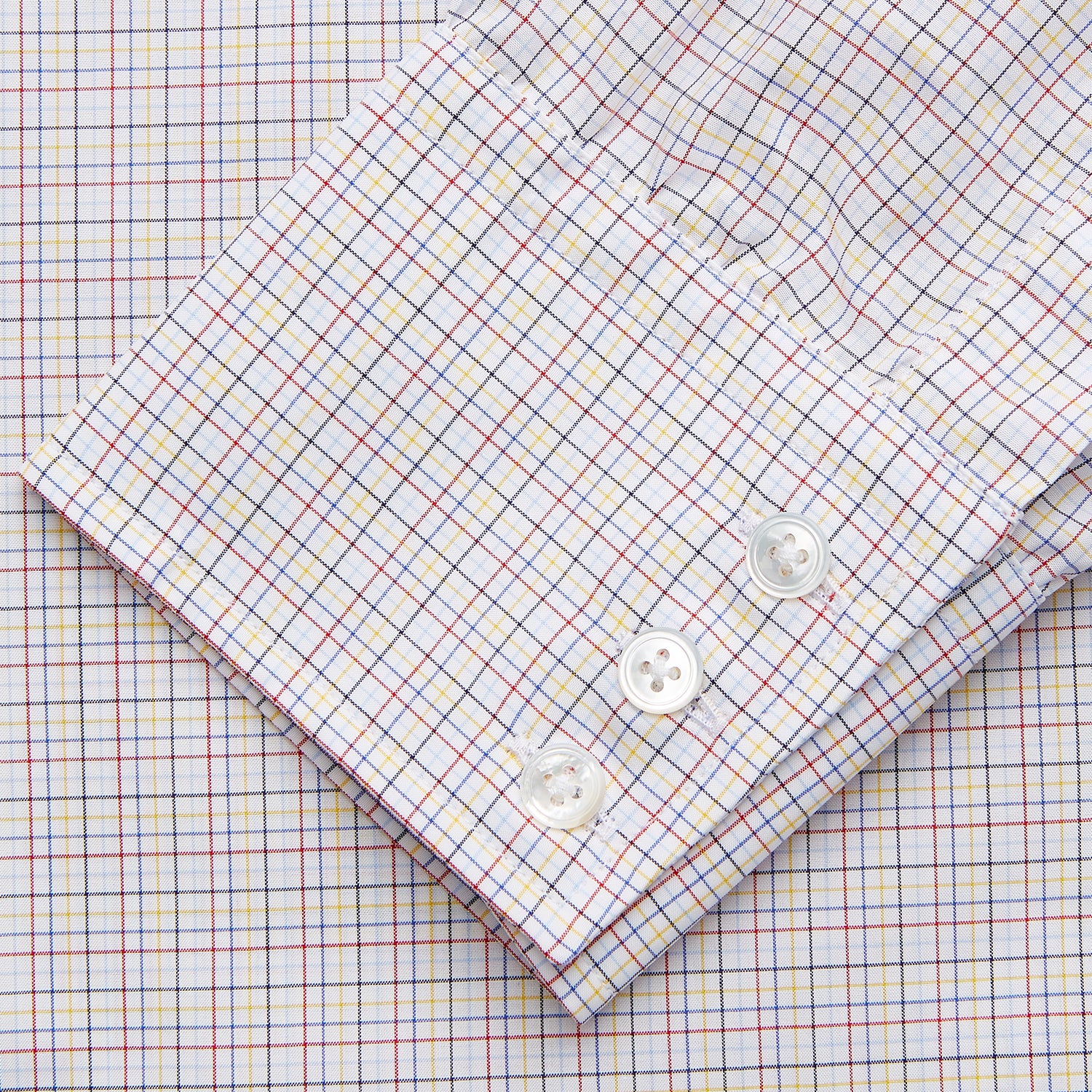 View 5 of product A man stands against a beige background, facing forward with a neutral expression and arms relaxed, wearing the Turnbull & Asser Red Multi Check Regular Fit Mayfair Shirt.