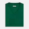 View 4 of product The Turnbull & Asser Hunter Green Fine Merino V-Neck Jumper is displayed against a white background, highlighting classic knitwear style.