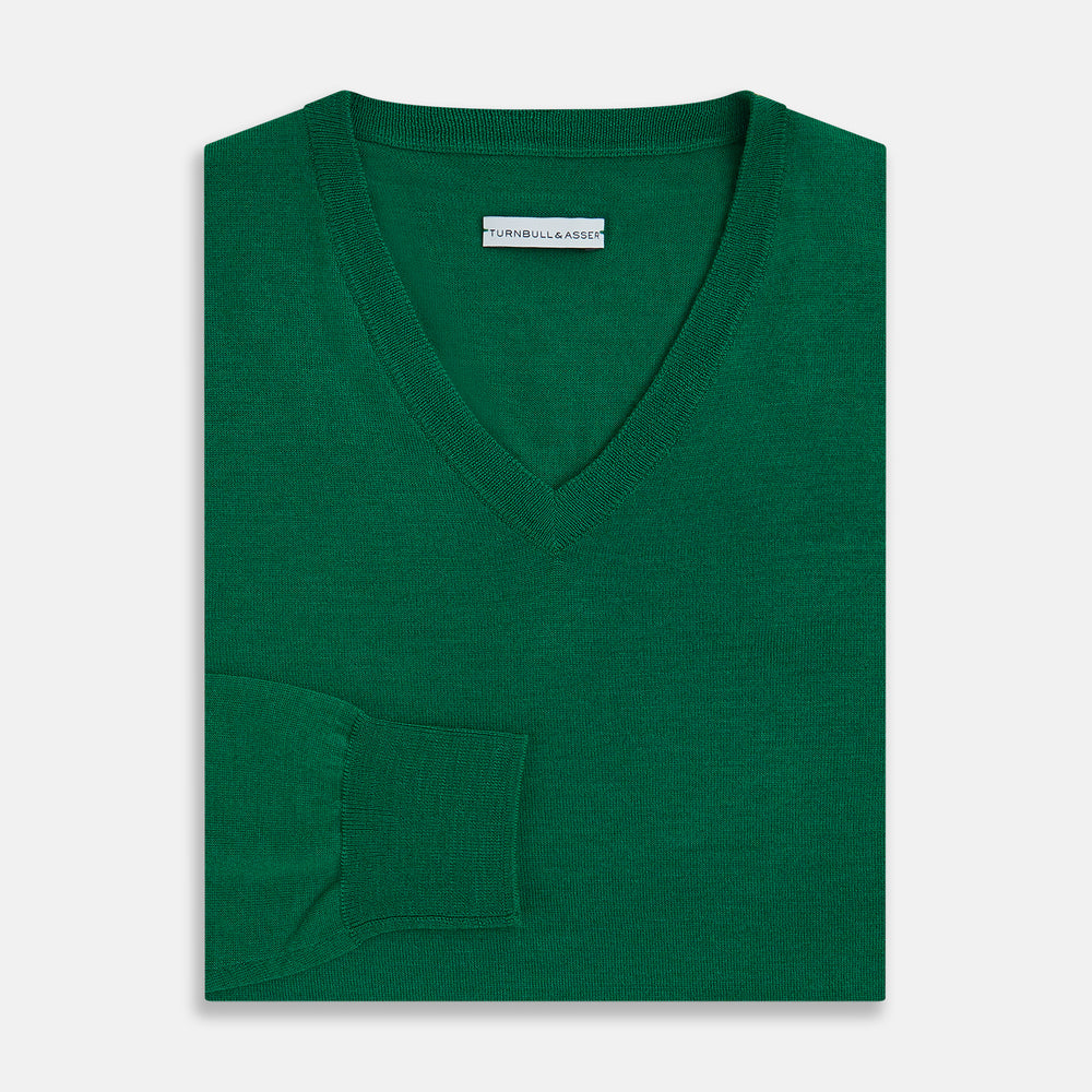 The Turnbull & Asser Hunter Green Fine Merino V-Neck Jumper is displayed against a white background, highlighting classic knitwear style.
