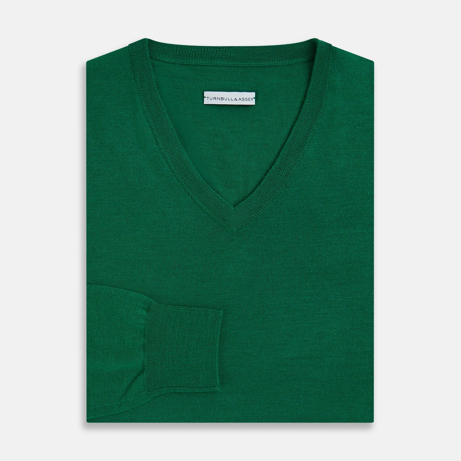 View 4 of product The Turnbull & Asser Hunter Green Fine Merino V-Neck Jumper is displayed against a white background, highlighting classic knitwear style.