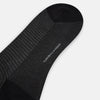 View 3 of product The Turnbull & Asser Charcoal Melange Houndstooth Mid-Length Sock features a black toe, heel, and cuff, and is shown singly against a plain white background.