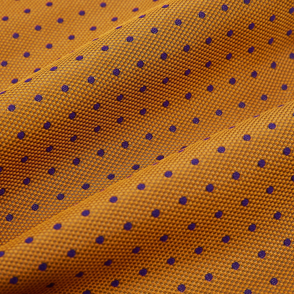The Navy and Orange Micro Dot Silk Cravat by Turnbull & Asser features a refined pattern of micro dots, bringing color and sophistication to formalwear, displayed against a white background.