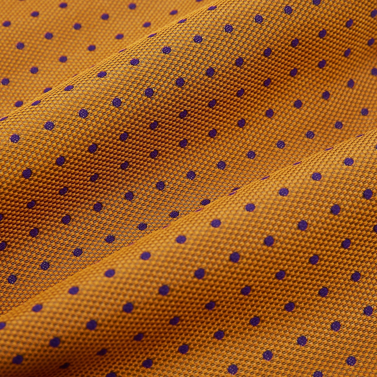 View 4 of product The Navy and Orange Micro Dot Silk Cravat by Turnbull & Asser features a refined pattern of micro dots, bringing color and sophistication to formalwear, displayed against a white background.