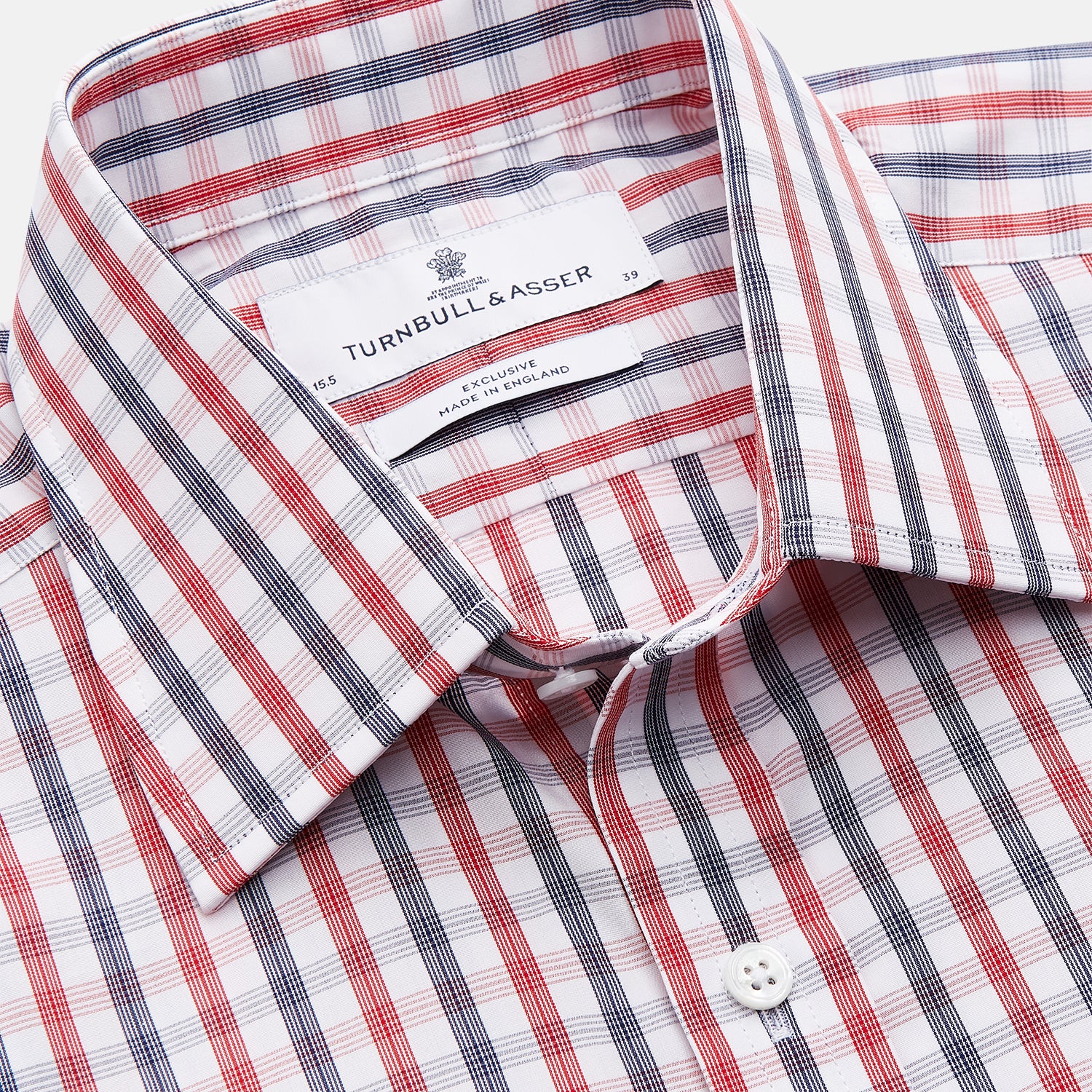 View 5 of product The Turnbull & Asser Navy and Red Check Cotton Regular Fit Mayfair Shirt features a classic T&A collar and long sleeves, shown laid flat on a white background.