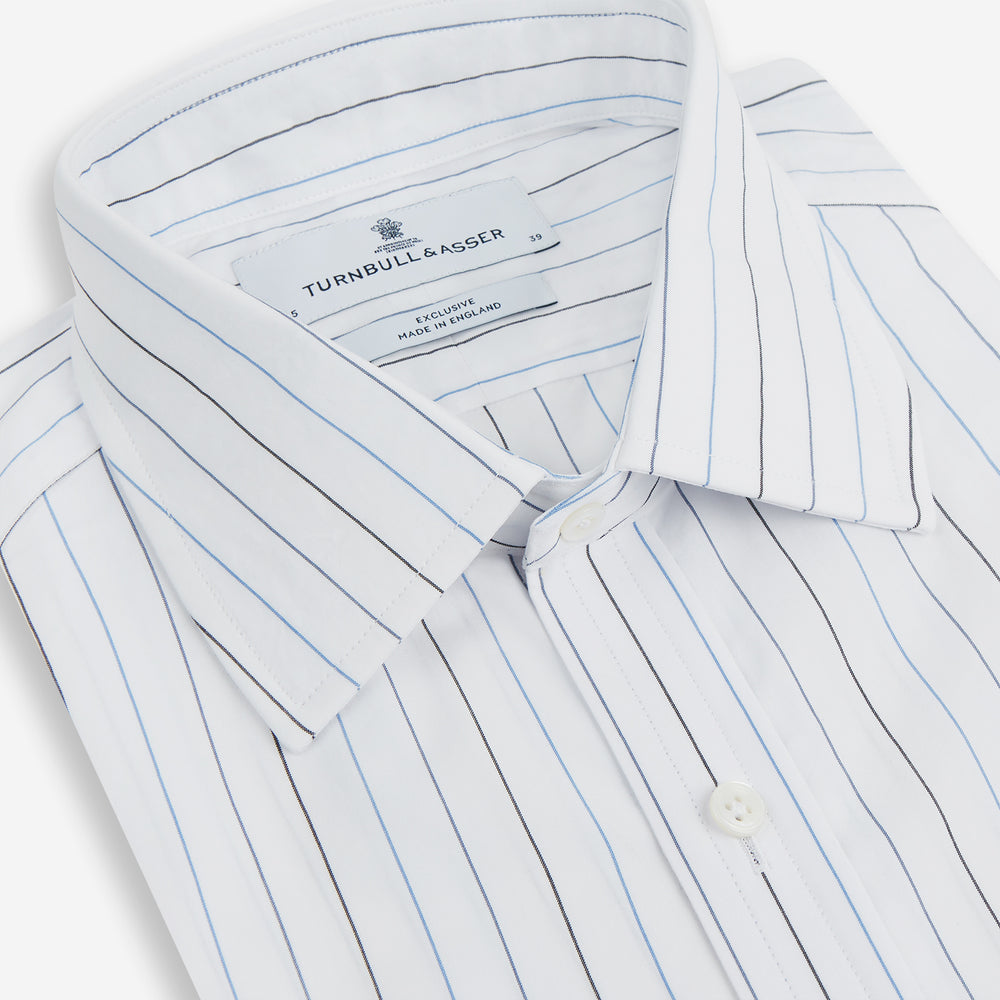 The Blue Wide Pinstripe Mayfair Shirt by Turnbull & Asser is a contemporary long-sleeve button-down with a collar, crafted from white fabric with bold vertical blue pinstripes. It is displayed neatly on a plain white background.