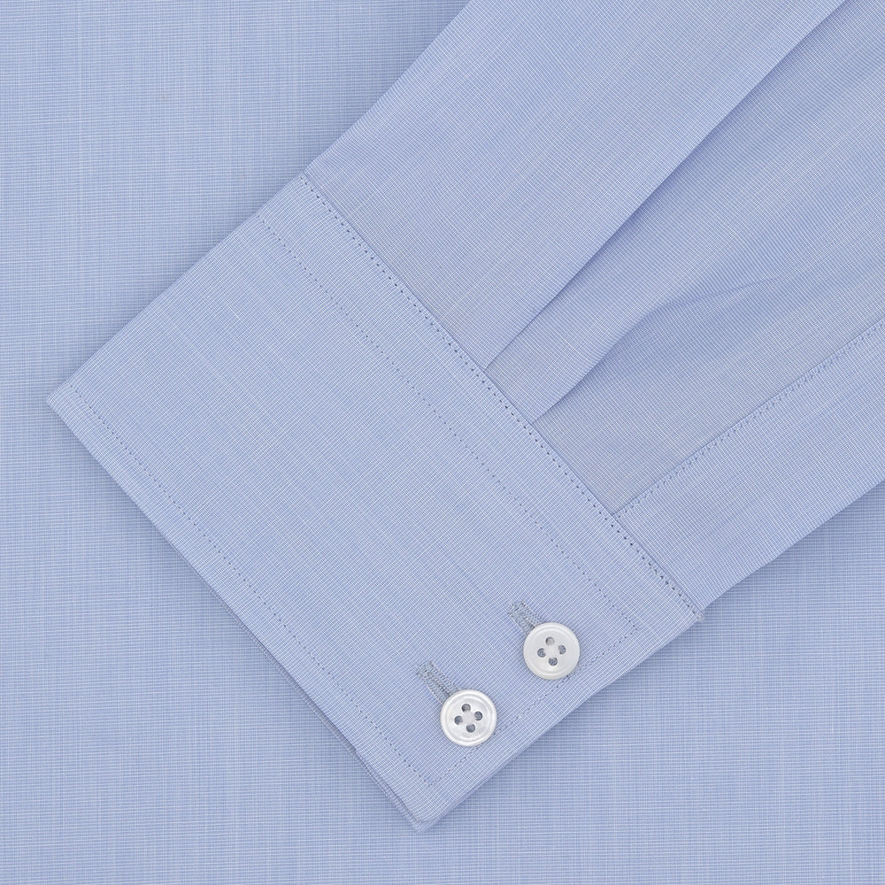 A Turnbull & Asser Tailored Fit Light Blue End-on-End Shirt with a Kent collar and 2-button cuffs is shown neatly folded on a plain white background. The shirt features classic styling and the Turnbull & Asser label.