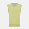 View 1 of product Turnbull & Asser’s Melon Green V-neck Cashmere Vest is shown on a plain white background. This sleeveless men’s jumper features ribbed neckline, armholes, and hem for subtle detail.