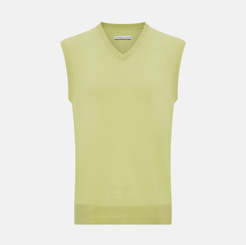 Turnbull & Asser’s Melon Green V-neck Cashmere Vest is shown on a plain white background. This sleeveless men’s jumper features ribbed neckline, armholes, and hem for subtle detail.