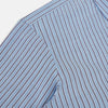 View 6 of product The Steel Blue Ticking Stripe Westminster Shirt by Turnbull & Asser features a classic fit, Turnbull collar, vertical stripes, white buttons, and buttoned cuffs—showcasing refined British craftsmanship.