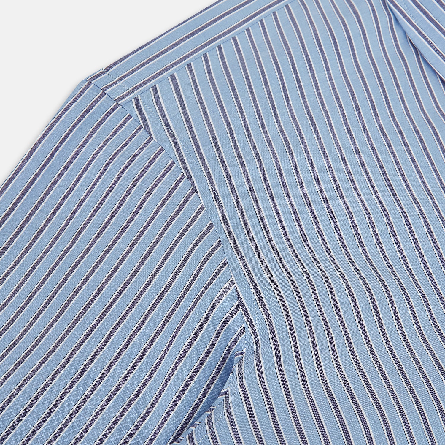 View 6 of product The Steel Blue Ticking Stripe Westminster Shirt by Turnbull & Asser features a classic fit, Turnbull collar, vertical stripes, white buttons, and buttoned cuffs—showcasing refined British craftsmanship.