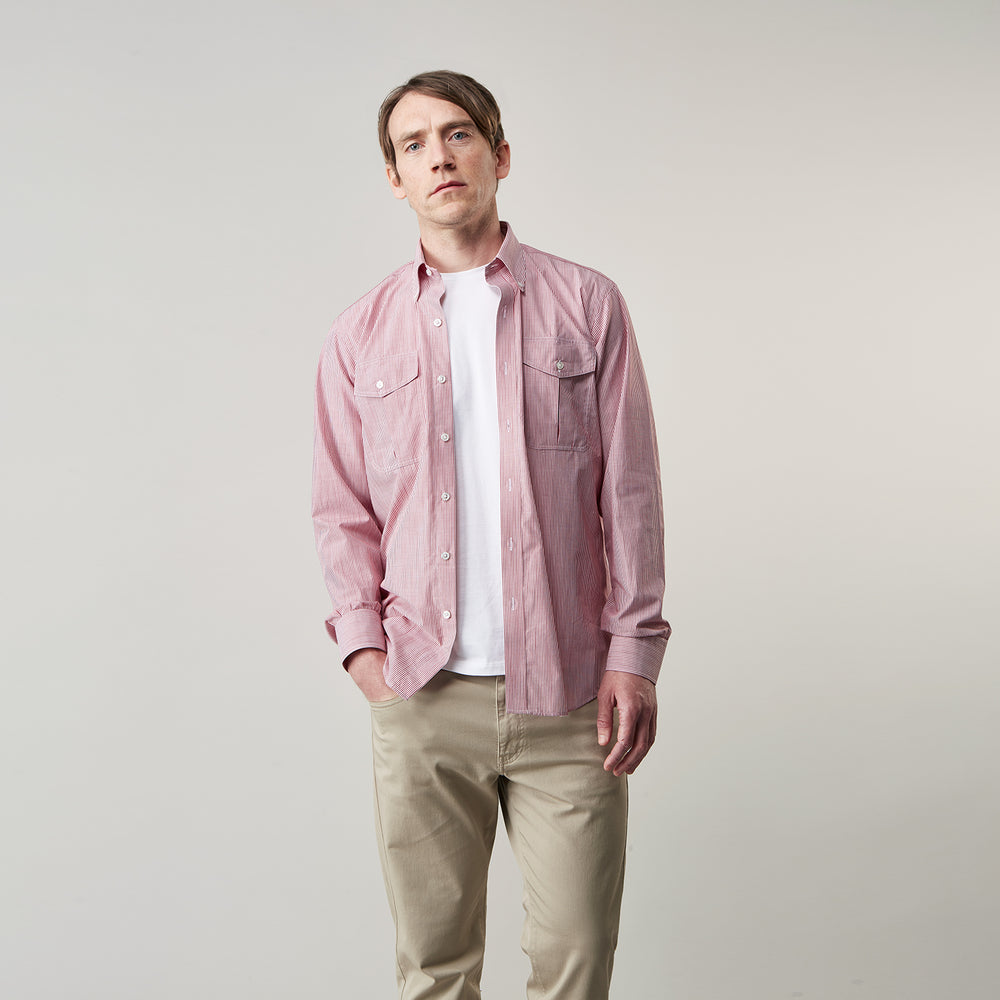 The Turnbull & Asser Dark Red Chambray Stripe Weekend Fit Shirt with a Dorset collar features striped cotton, two chest pockets with button flaps, and white front and cuff buttons—perfect for a relaxed yet stylish weekend look.
