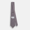 View 4 of product The Turnbull & Asser Ash Medallion Silk Tie features rolled-up ash silk with gray and light purple medallion and grid-like motifs on a white background.