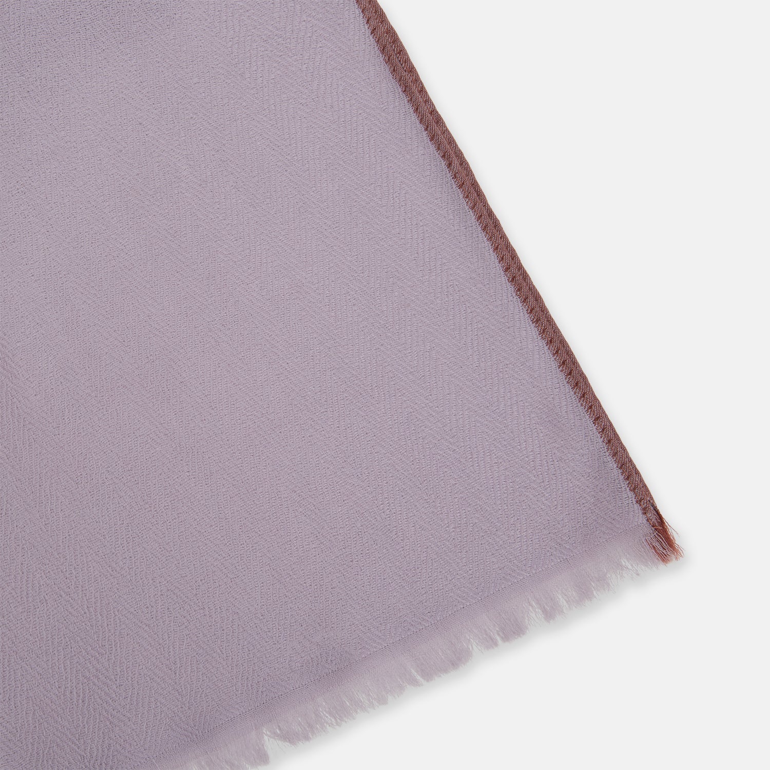 View 2 of product The Lilac Cashmere Scarf by Turnbull & Asser features a soft texture and unfinished, slightly frayed edges—an elegant accessory for any formal wardrobe.