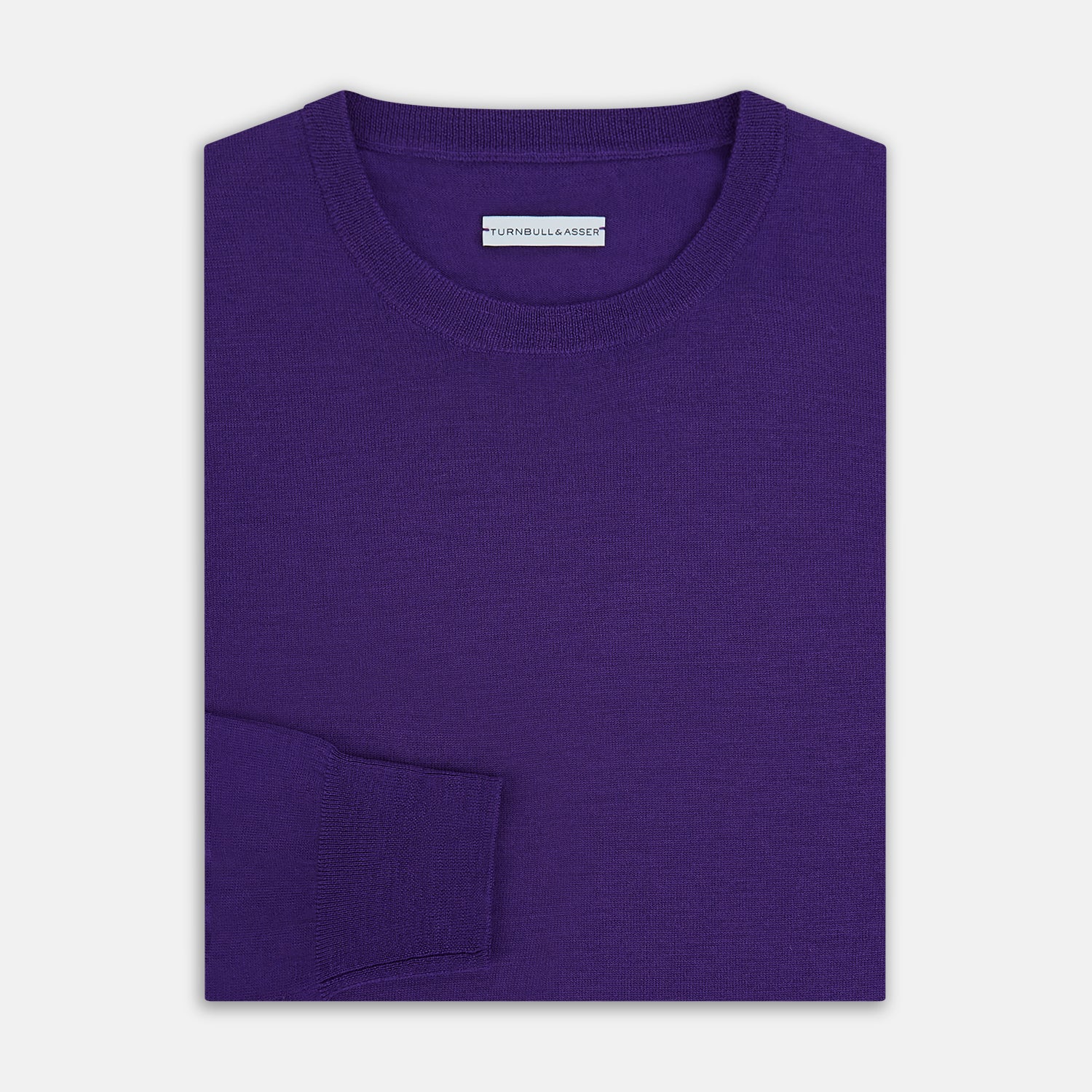 View 4 of product The Turnbull & Asser Purple Merino Round Neck Jumper, a classic men’s knitwear piece, is shown against a white background.