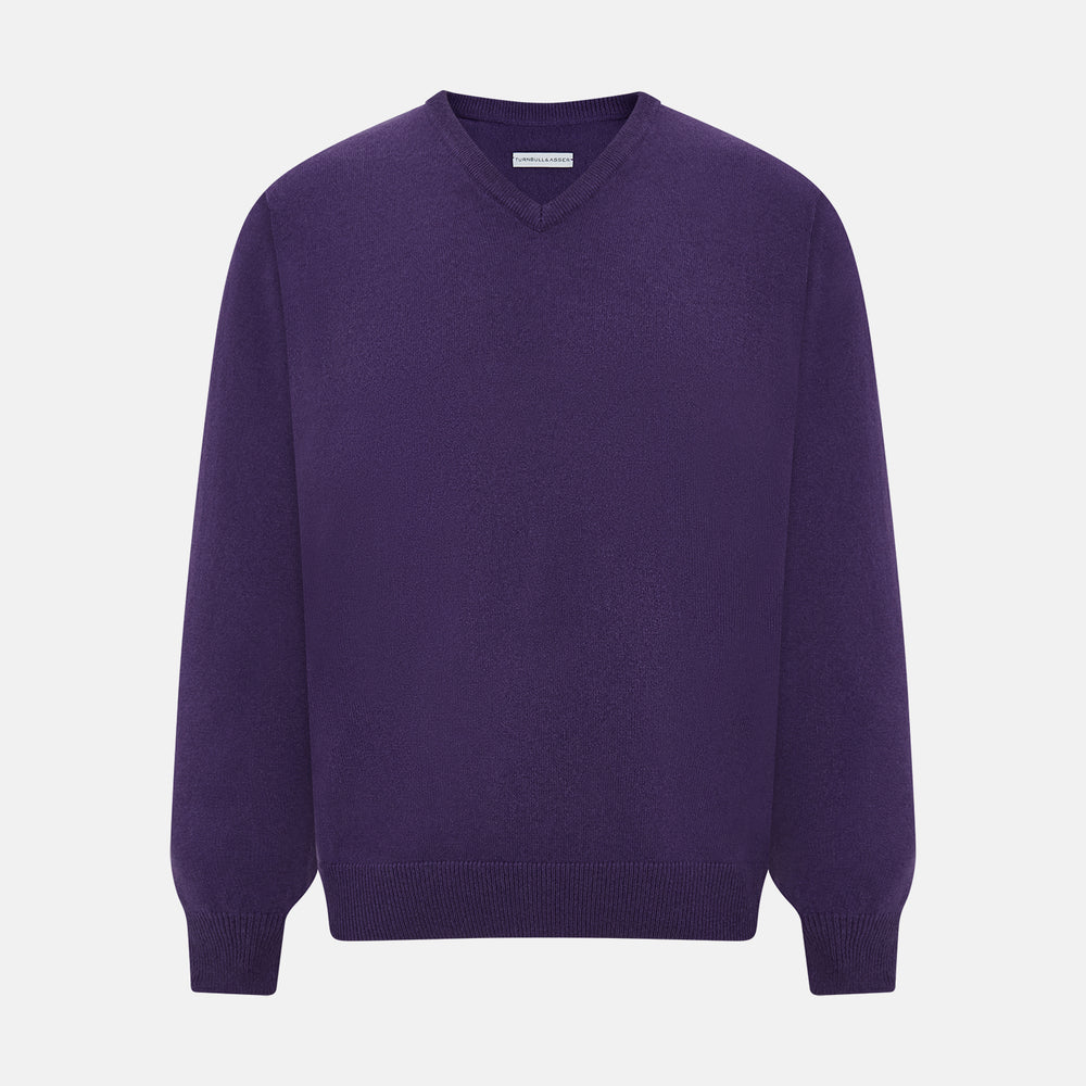 The Turnbull & Asser Purple Cashmere V-neck Jumper features long sleeves with ribbed cuffs and hem—a classic knitwear piece for effortless layering, shown against a white background.