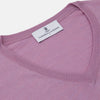 View 2 of product The Pink Merino Kennedy V-Neck Jumper by Turnbull & Asser features long sleeves with ribbed cuffs and waistband, shown on a plain white background—ideal for knitwear lovers.
