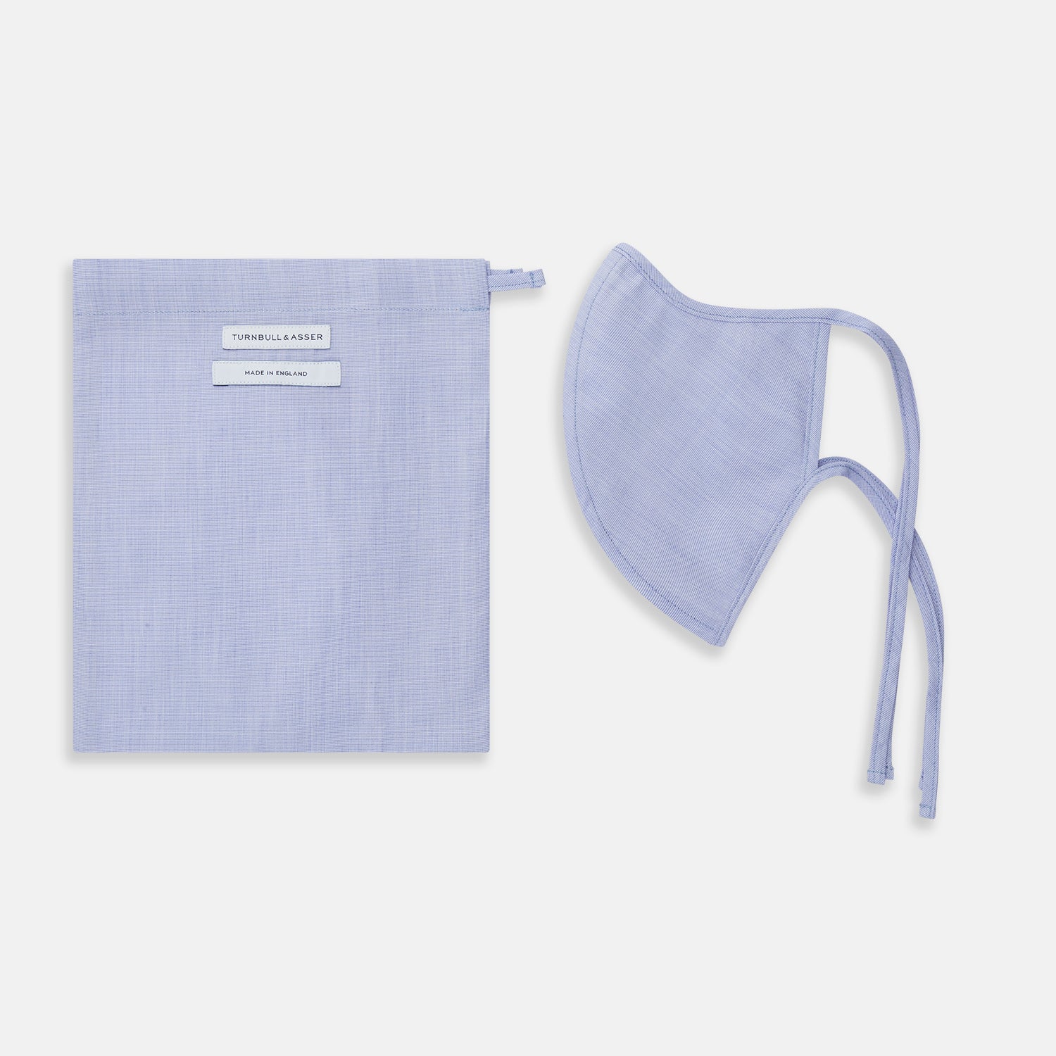 View 2 of product The Turnbull & Asser Plain Pale Blue Commuter Mask with 3 Viroformula™ filters features adjustable ear loops and side ties—ideal for daily use, shown against a white background.