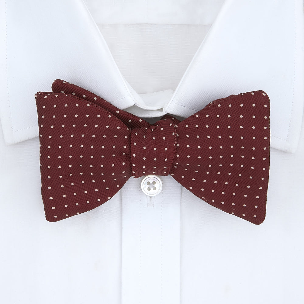 The Turnbull & Asser Burgundy and White Small Spot Printed Silk Bow Tie is shown on a plain white background.