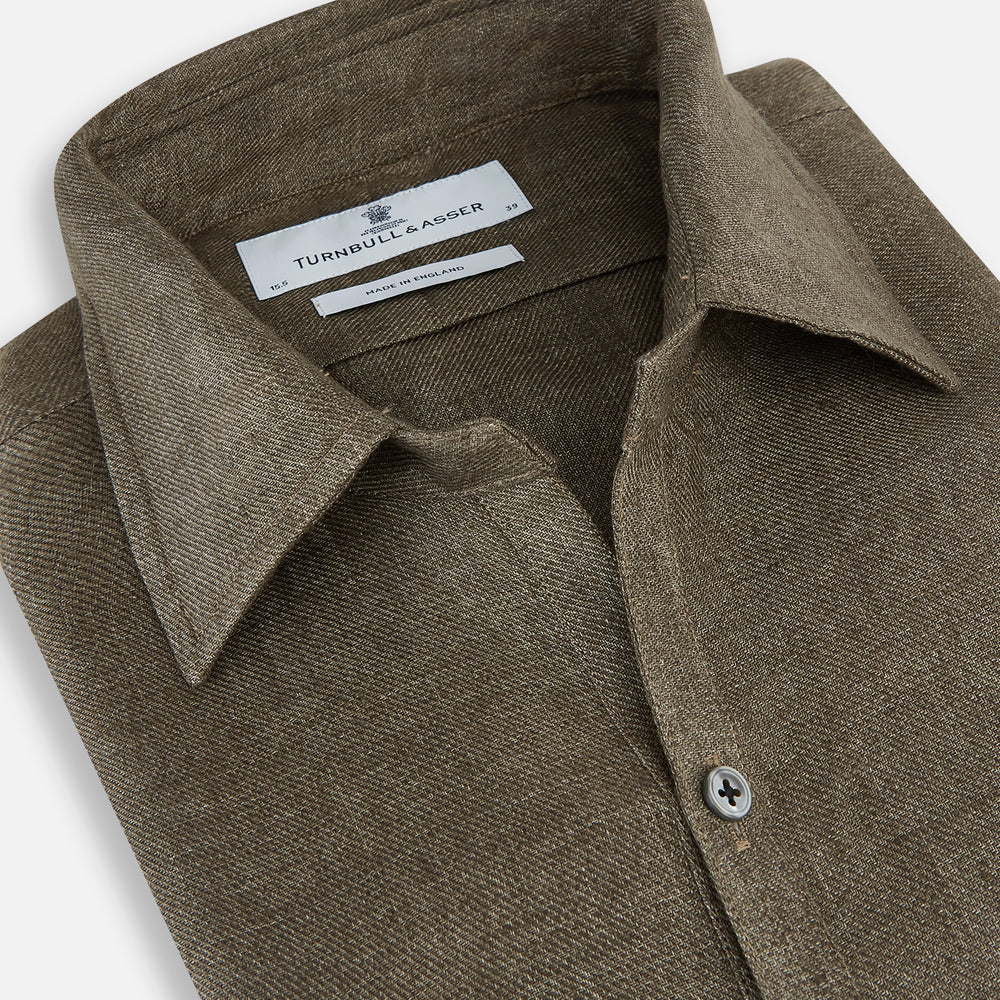 The Olive Linen Windsor Shirt by Turnbull & Asser features long sleeves, a classic Windsor collar, buttoned cuffs, and a straight hem—expertly crafted in Britain and shown against a white background.