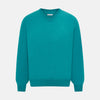 View 1 of product The Turnbull & Asser Turquoise Fine Merino V-Neck Jumper features long sleeves, ribbed cuffs and waistband, shown on a white background—a timeless choice for classic knitwear enthusiasts.