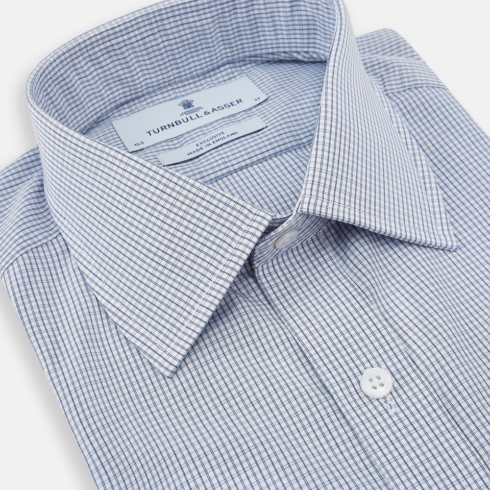 The Turnbull & Asser Blue Micro Graph Check Mayfair Shirt features long sleeves, a subtle check pattern, T&A collar, and buttoned cuffs, shown laid flat on a white background.