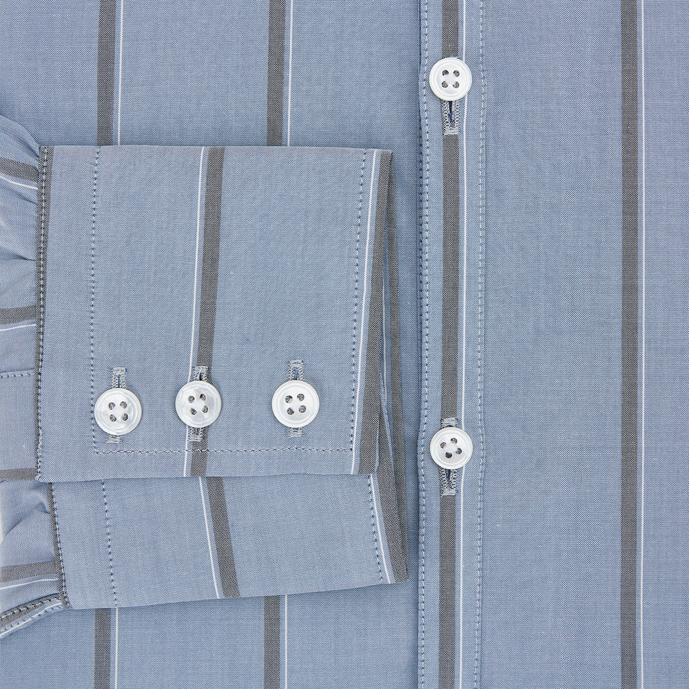 The Steel Blue Track Stripe Westminster Shirt by Turnbull & Asser features dark pinstripes, a classic collar, white buttons, and buttoned cuffs—expertly crafted to highlight British craftsmanship. Laid flat on white background.