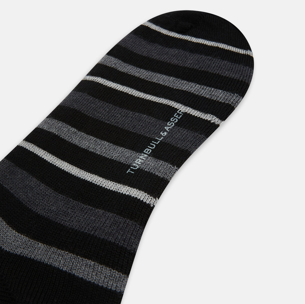The Turnbull & Asser Chocolate Melange Striped Merino Wool Long Sock features black, dark gray, and light gray horizontal stripes and is displayed individually on a white background.
