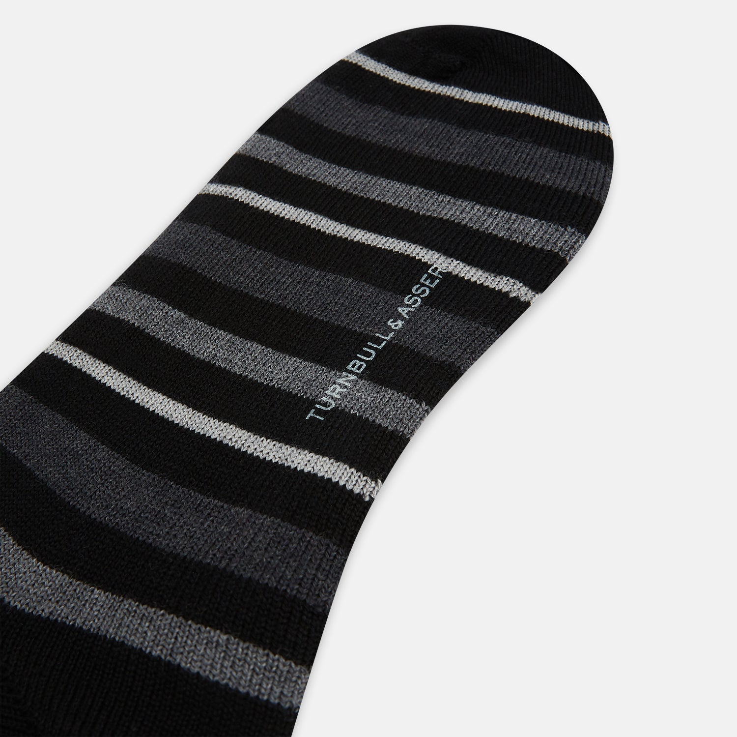 View 3 of product The Turnbull & Asser Chocolate Melange Striped Merino Wool Long Sock features black, dark gray, and light gray horizontal stripes and is displayed individually on a white background.