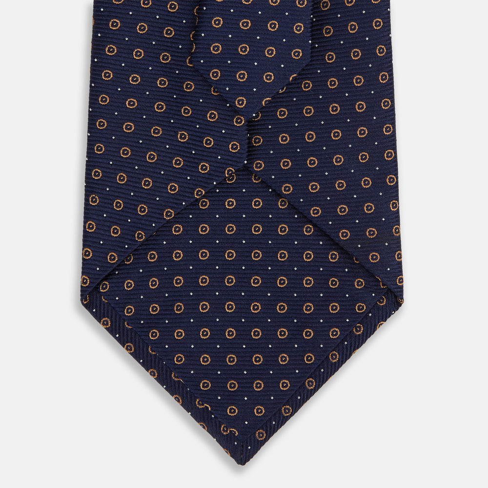 The Turnbull & Asser Navy and Brown Circle Silk Tie features an elegant pattern, perfect for adding a refined touch to your modern office attire.