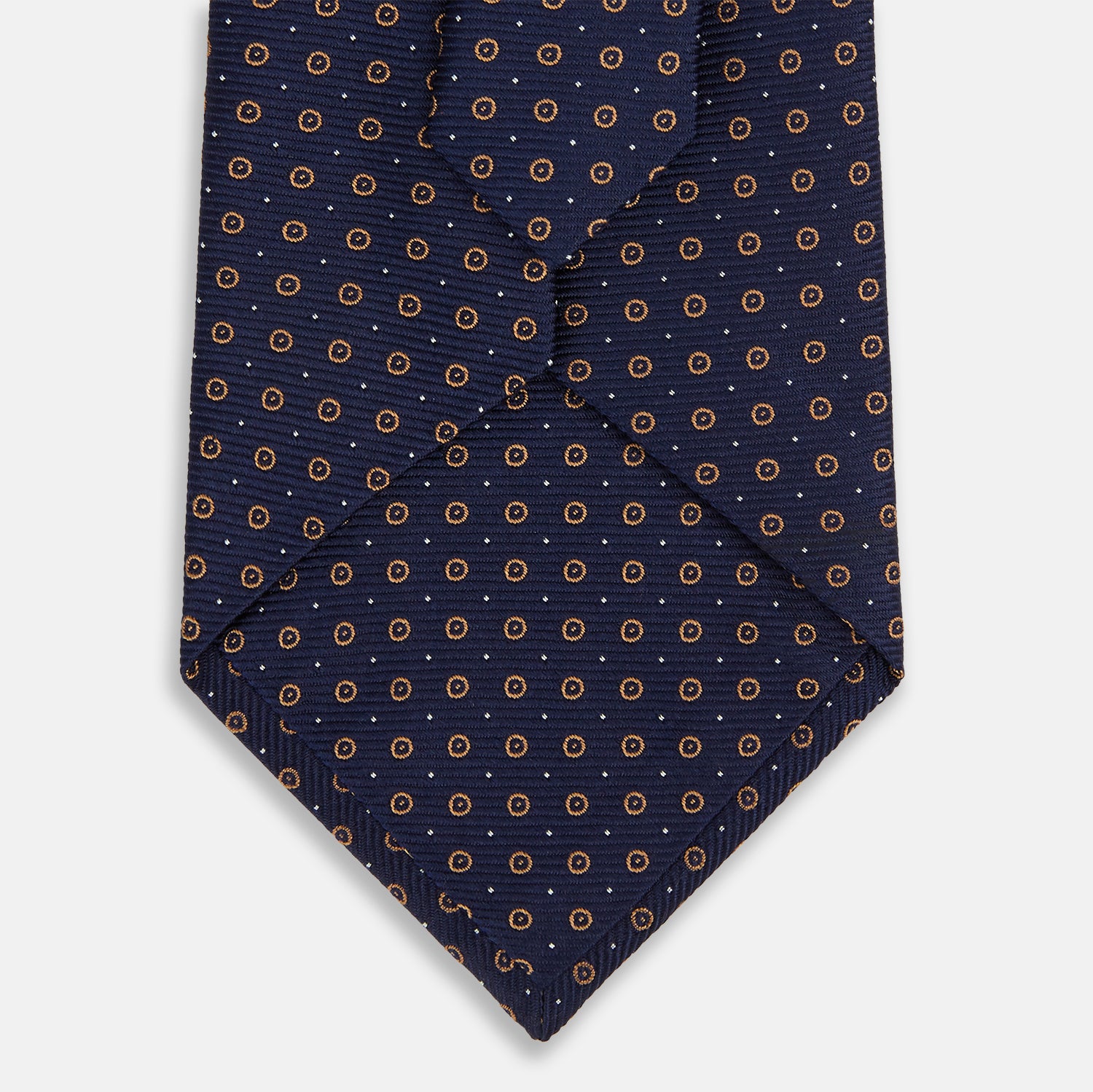 View 3 of product The Turnbull & Asser Navy and Brown Circle Silk Tie features an elegant pattern, perfect for adding a refined touch to your modern office attire.