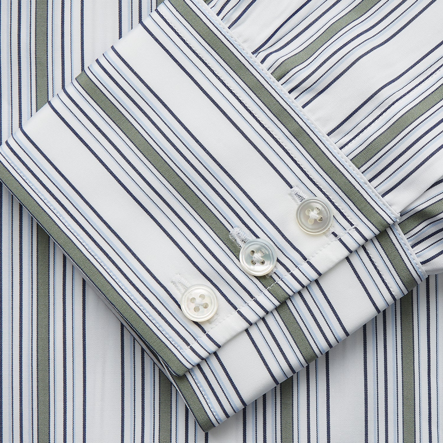 View 3 of product The Turnbull & Asser Green Multi Stripe Regular Fit Shirt features a T&A collar, 3 button cuffs, long sleeves, and vertical blue, green, and white stripes. Laid flat on a white background.