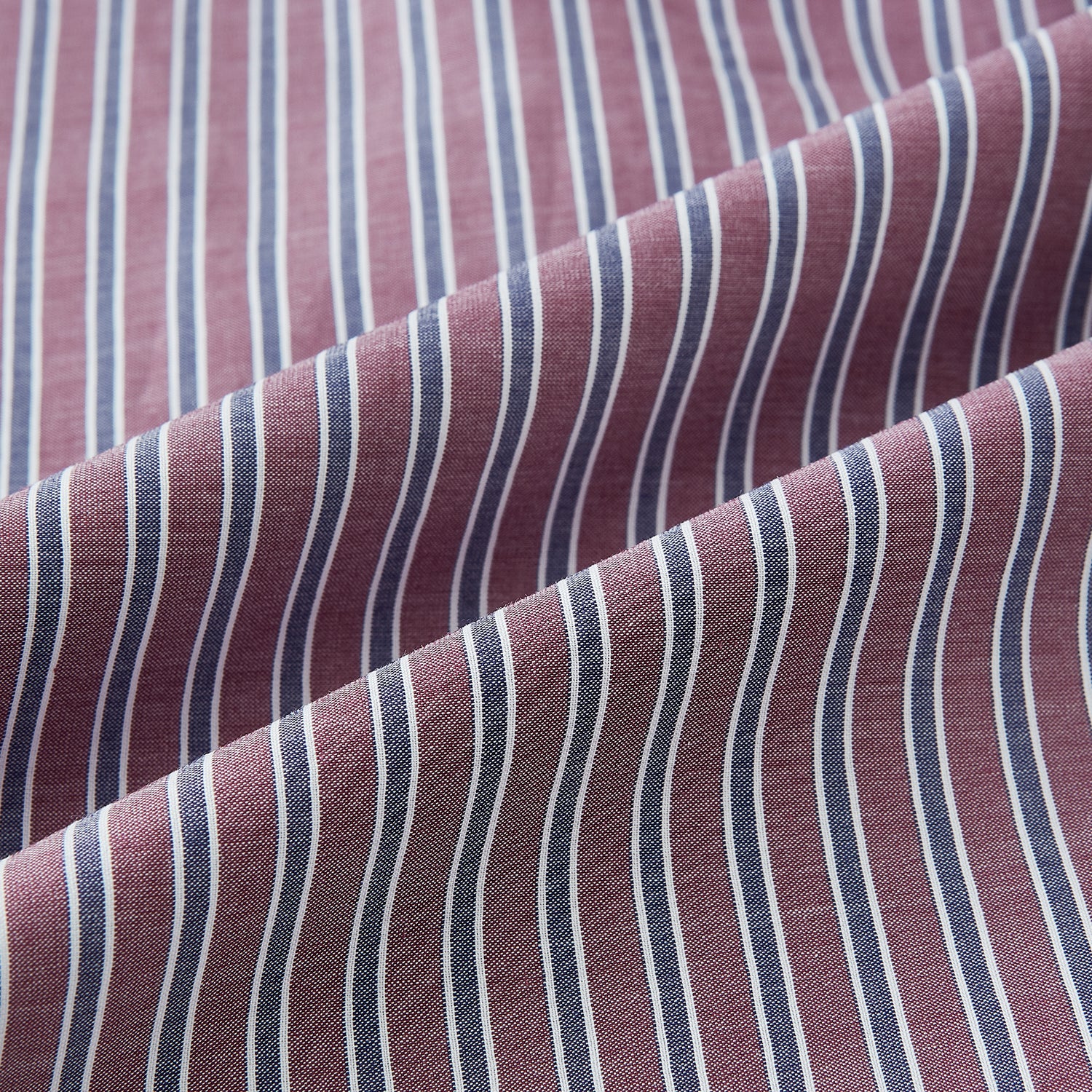 View 8 of product The Turnbull & Asser Wine Ticking Stripe Westminster Shirt features red, blue, and white vertical pinstripes on white and is shown laid flat on a white surface.