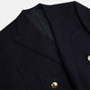 View 2 of product The Turnbull & Asser Navy Double Breasted Classic Blazer features gold buttons, peaked lapels, and multiple front pockets, exemplifying classic British tailoring against a plain light background.