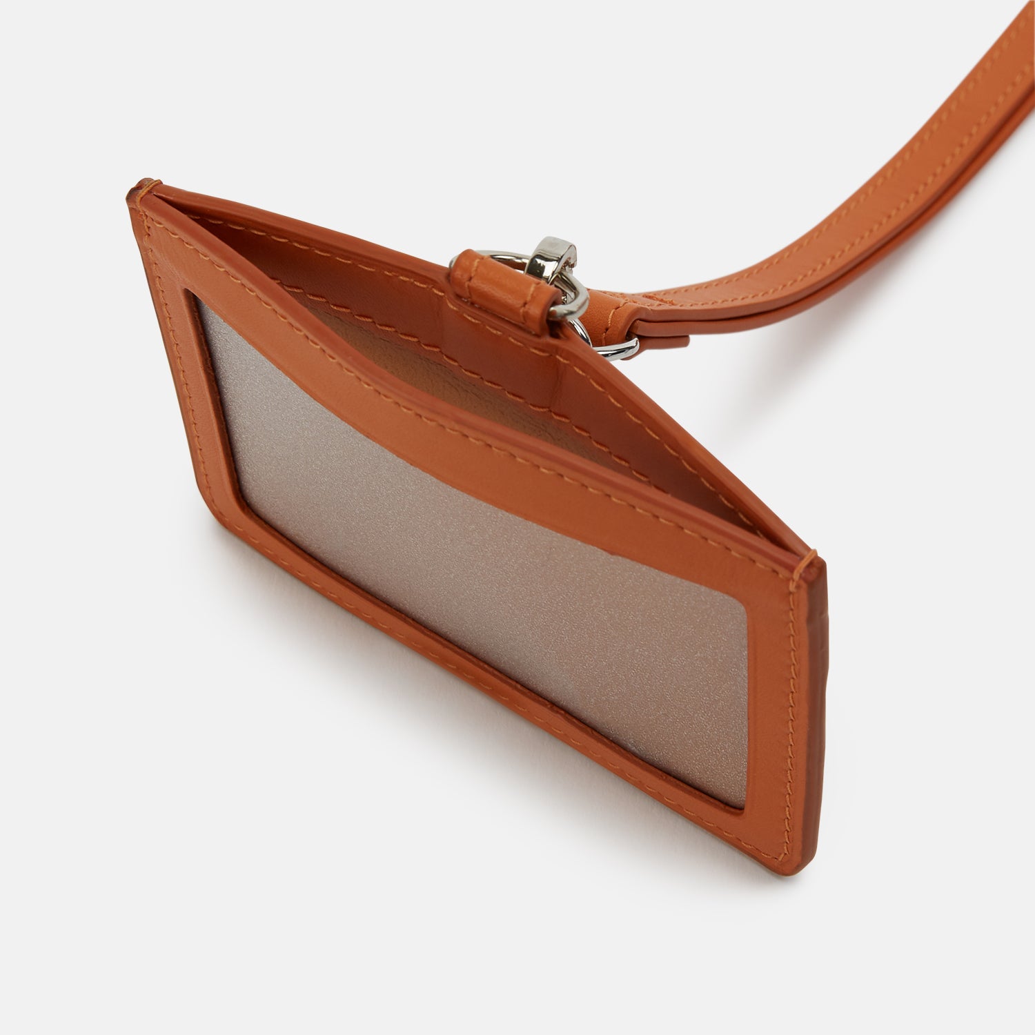 View 2 of product A tan Turnbull & Asser ID Card Holder made of Italian leather, featuring a matching lanyard and small tag. "Turnbull & Asser" is elegantly embossed in gold on the front, set against a plain white background.