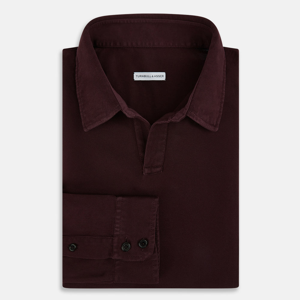 The Turnbull & Asser Burgundy Rugby Polo Shirt is a long-sleeve, pure cotton collared top with no visible buttons, shown laid flat on a white background.