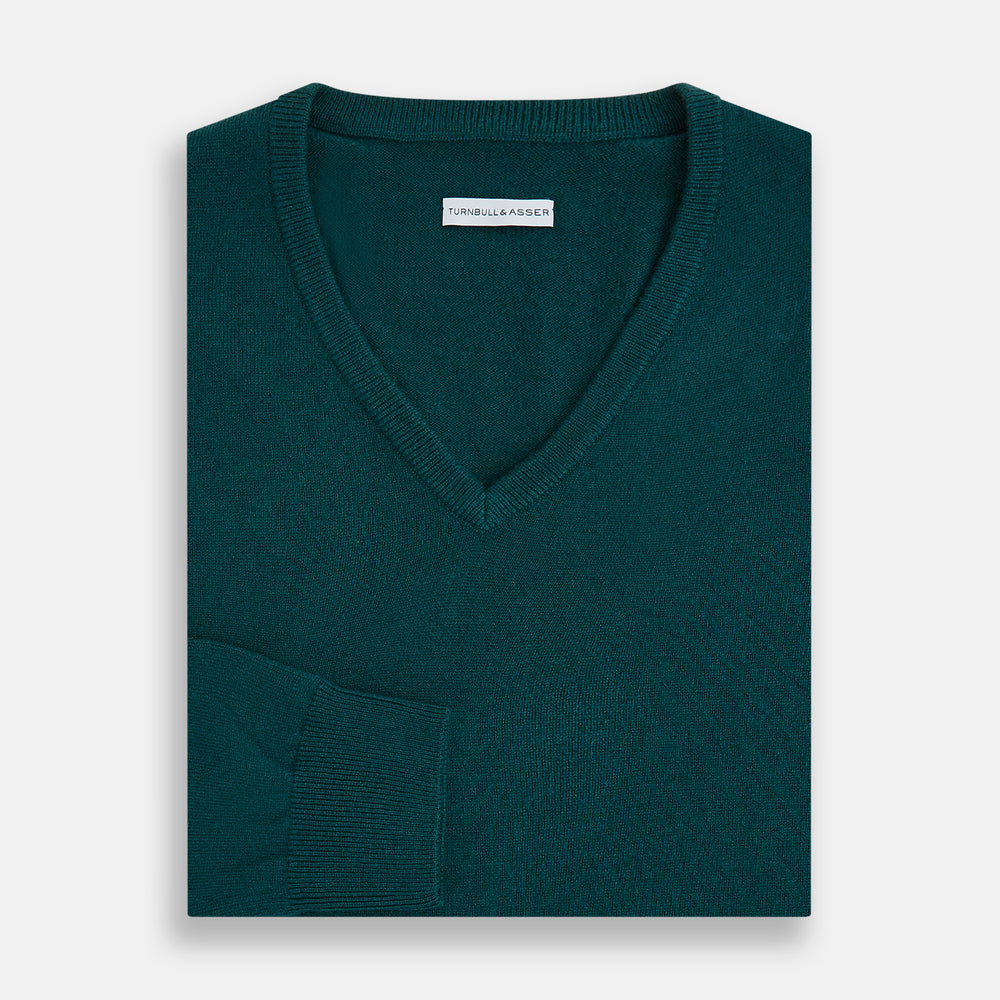 The Moss Green Cashmere V-Neck Jumper by Turnbull & Asser features long sleeves with ribbed cuffs and hem, shown on a plain white background.
